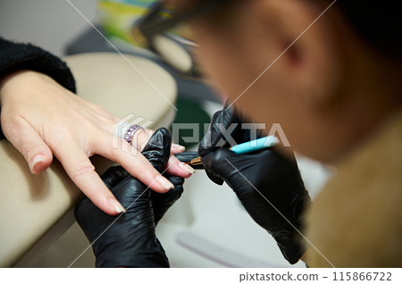 Professional manicure service at beauty salon with black gloves Professional manicure service at beauty salon with black gloves 115866722