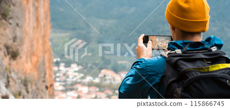 Man is making photos on mobile phone during travel. 115866745