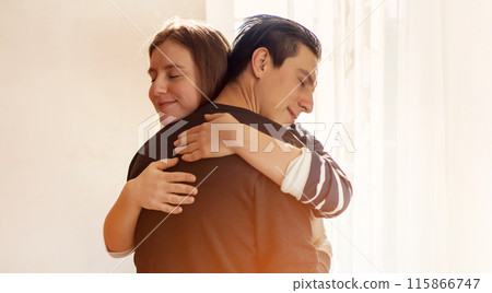A couple in romantic relationship, girl warm hugs a man. A couple in romantic relationship, girl warm hugs a man. 115866747