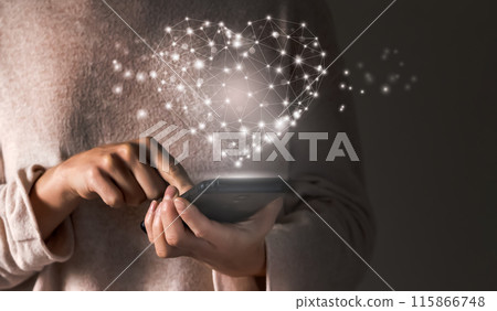 Girl holds a mobile phone and send a heart with love. 115866748