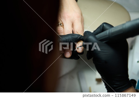 Manicure procedure at beauty salon with black gloves Manicure procedure at beauty salon with black gloves 115867149