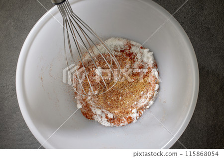 spices with salt and baking powder are mixed in a white bowl spices with salt and baking powder are mixed in a white bowl 115868054