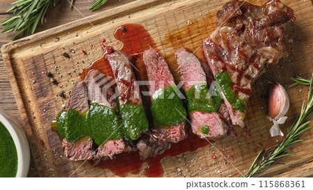 freshly grilled sliced steak with green parsley sauce freshly grilled sliced steak with green parsley sauce 115868361