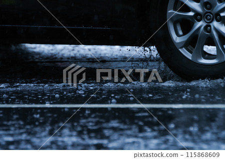 A car splashing water A car splashing water 115868609