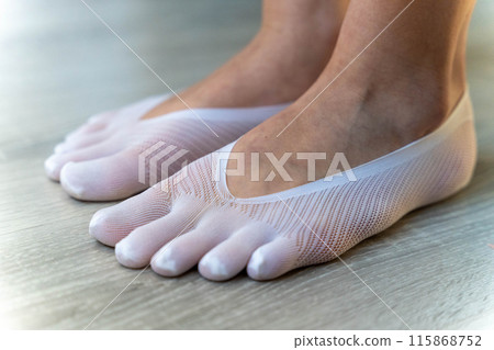 White toe socks on a wooden floor 115868752
