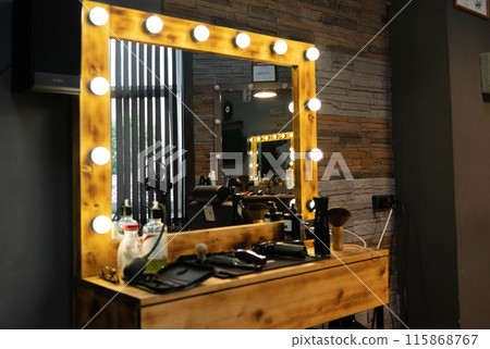 Wooden vanity mirror with lights in a barber shop Wooden vanity mirror with lights in a barber shop 115868767