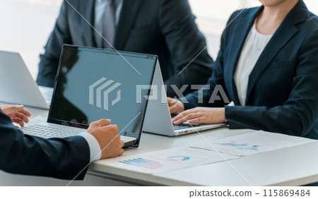 Men and women in suits working using laptops and PCs in companies, companies, and offices Men and women in suits working using laptops and PCs in companies, companies, and offices 115869484
