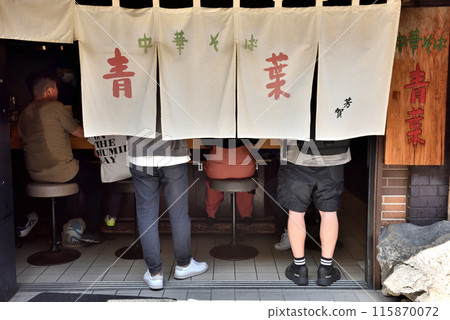 Ramen shop curtain and customers waiting in line Ramen shop curtain and customers waiting in line 115870072