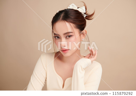 Beautiful young asian woman with clean fresh skin on beige background, Face care, Facial treatment, Cosmetology, beauty and spa, Asian women portrait. 115870292