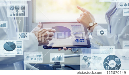 Researchers and digital data in a meeting using a tablet 115870349