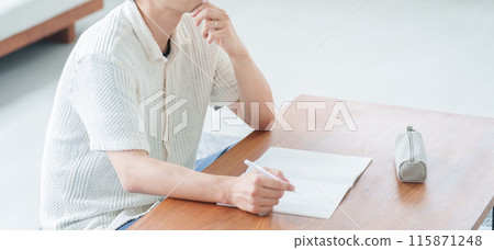 A working man studying at home 115871248