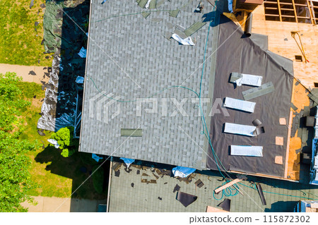 Replacing old asphalt bitumen shingles on roof of house Replacing old asphalt bitumen shingles on roof of house 115872302