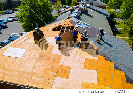 Replace old asphalt bitumen shingles on house roof in order to repair roof 115872304