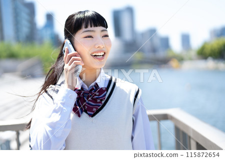 High school girl talking on a smartphone High school girl talking on a smartphone 115872654