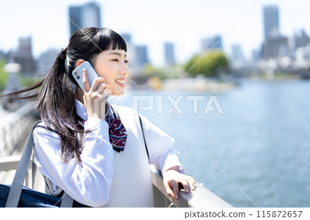 High school girl talking on a smartphone 115872657