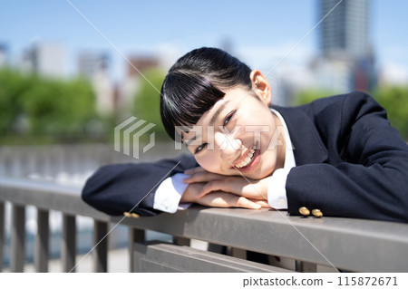 A high school girl leaning on the railing on the roof A high school girl leaning on the railing on the roof 115872671