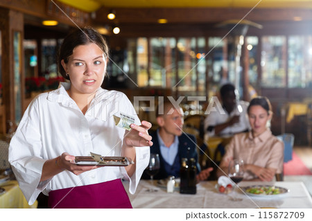 Waiter demonstrating his upset with little tips from restaurant visitors Waiter demonstrating his upset with little tips from restaurant visitors 115872709