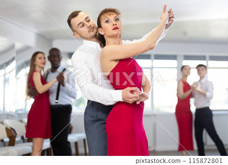 Young man and woman dancing waltz in couple during lesson at studio Young man and woman dancing waltz in couple during lesson at studio 115872801