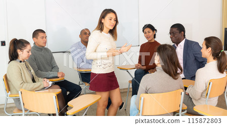 People listening to speaker during therapy session in support group People listening to speaker during therapy session in support group 115872803