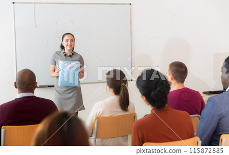 Businesswoman giving talk at modern office conference to multiethnic team in front of whiteboard Businesswoman giving talk at modern office conference to multiethnic team in front of whiteboard 115872885
