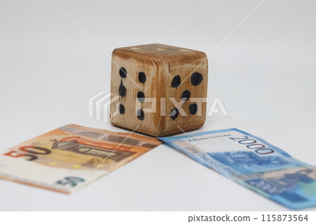 Homemade dice lies on banknotes, unpredictability of financial markets 115873564