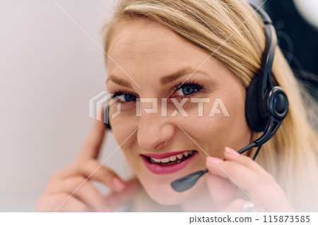 Friendly Call Center Agent Answering Incoming Calls with Headset Providing Remote Customer Service. Friendly Call Center Agent Answering Incoming Calls with Headset Providing Remote Customer Service. 115873585