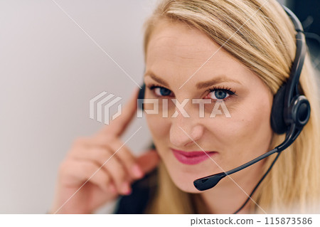 Friendly Call Center Agent Answering Incoming Calls with Headset Providing Remote Customer Service. Friendly Call Center Agent Answering Incoming Calls with Headset Providing Remote Customer Service. 115873586