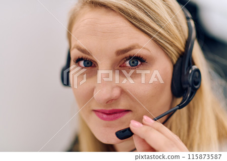 Friendly Call Center Agent Answering Incoming Calls with Headset Providing Remote Customer Service. Friendly Call Center Agent Answering Incoming Calls with Headset Providing Remote Customer Service. 115873587
