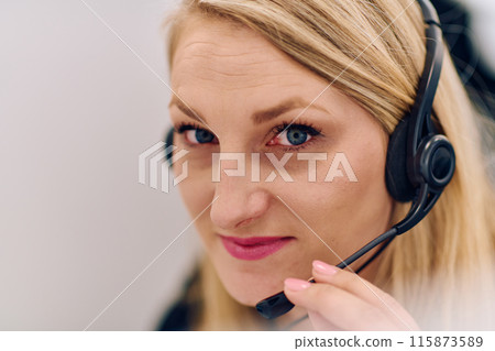 Friendly Call Center Agent Answering Incoming Calls with Headset Providing Remote Customer Service. Friendly Call Center Agent Answering Incoming Calls with Headset Providing Remote Customer Service. 115873589