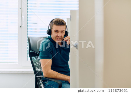Close Up Portrait of a Customer Support Representative in a Call Center Environment. 115873661