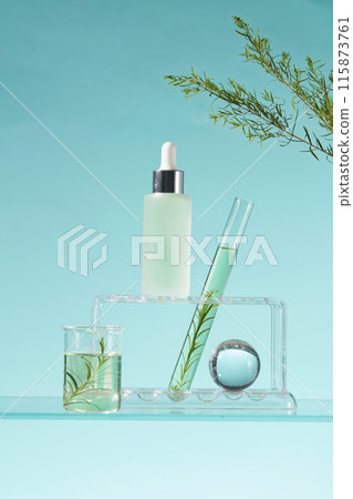 Blank label glass bottle standing on a rack displayed with a beaker and a test tube of green liquid. Natural beauty blank label for branding mock-up concept. Research science content 115873761