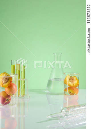 Template photo for nature cosmetic product advertisement, which has peach as the one of ingredient. Displaying space in center, lab glassware and fresh peach decorated on both sides 115873812