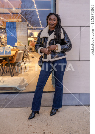 A fashionable woman standing confidently in front of a modern coffee shop in stylish jacket A fashionable woman standing confidently in front of a modern coffee shop in stylish jacket 115873863