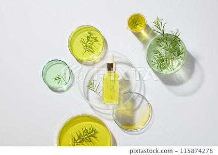 A lot of laboratory petri dishes filled with liquid in green and yellow color decorated with a glass bottle without label. Blank label for cosmetic product mockup A lot of laboratory petri dishes filled with liquid in green and yellow color decorated with a glass bottle without label. Blank label for cosmetic product mockup 115874278