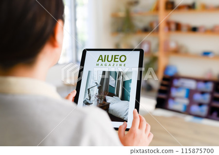 A woman who operates a tablet A woman who operates a tablet 115875700