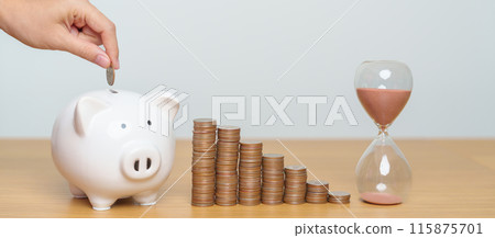 Money Saving for Future Plan, Retirement fund, Pension, Investment, Wealth Business and Financial concepts. hand putting coin into piggy bank with sandglass, Counting and stack arrangement for deposit 115875701