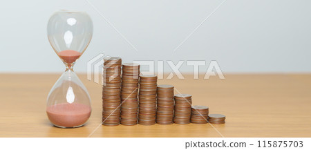 Money Saving for Future Plan, Retirement fund, Pension, Investment, Wealth Business and Financial concepts. coins money stack with sandglass on table 115875703