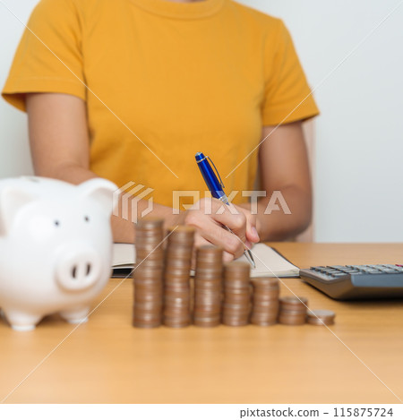 Money Saving for Future Plan, Retirement fund, Pension, Investment, Wealth Business and Financial concepts. Woman Counting and calculate money with coins stack with piggy bank for deposit 115875724