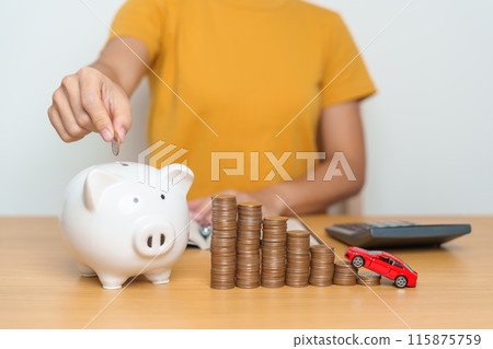 Money Saving, Car Insurance, Financial, vehicle Repair and Maintenance concepts. hand putting coin into piggy bank with Auto model, Money stack Counting arrangement for deposit and Automobile Tax Money Saving, Car Insurance, Financial, vehicle Repair and Maintenance concepts. hand putting coin into piggy bank with Auto model, Money stack Counting arrangement for deposit and Automobile Tax 115875759