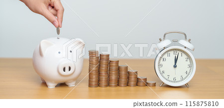Money Saving for Future Plan, Retirement fund, Pension, Investment, Wealth Business and Financial concepts. hand putting coin into piggy bank with clock, Counting and stack arrangement for deposit 115875810