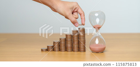 Money Saving for Future Plan, Retirement fund, Pension, Investment, Wealth Business and Financial concepts. hand putting coin on money stack with sandglass 115875813