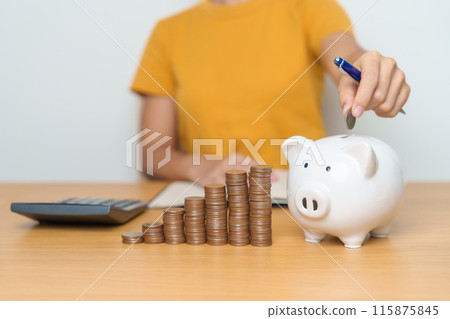 Money Saving for Future Plan, Retirement fund, Pension, Investment, Wealth Business and Financial concepts. hand putting coin into piggy bank, Money Counting and calculate for deposit Money Saving for Future Plan, Retirement fund, Pension, Investment, Wealth Business and Financial concepts. hand putting coin into piggy bank, Money Counting and calculate for deposit 115875845
