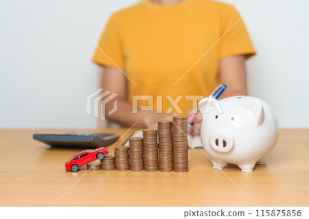 Money Saving, Car Insurance, Financial, vehicle Repair and Maintenance concepts. coins stack and piggy bank with Auto model, Money stack Counting arrangement for deposit and Automobile Tax 115875856