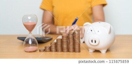 Money Saving for Future Plan, Retirement fund, Pension, Investment, Wealth Business and Financial concepts. woman with coins stack, piggy bank and sandglass for money Counting and deposit 115875859