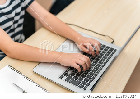 Hands of an elementary school boy receiving programming education and using a laptop Hands of an elementary school boy receiving programming education and using a laptop 115876324