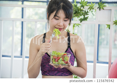 Wellness Asian women dressing organic green salad tomato vegetable dish. Beautiful girl healthcare vegan wellness lifestyle concept. Healthy woman workout holding organic salad bowl healthy lifestyle Wellness Asian women dressing organic green salad tomato vegetable dish. Beautiful girl healthcare vegan wellness lifestyle concept. Healthy woman workout holding organic salad bowl healthy lifestyle 115876542