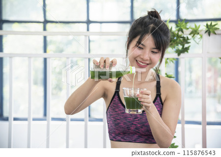 Women hands holding smoothie detox green juice fresh fruit cool drinking. Asian women smile laugh drinking vegan vegetable cool wellness beverage. Female pouring celery juice drink cocktail glass Women hands holding smoothie detox green juice fresh fruit cool drinking. Asian women smile laugh drinking vegan vegetable cool wellness beverage. Female pouring celery juice drink cocktail glass 115876543