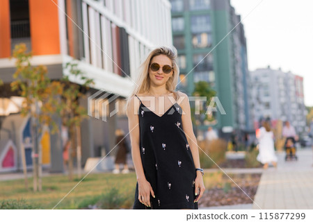 Happy young woman walking on city streets Happy young woman walking on city streets 115877299