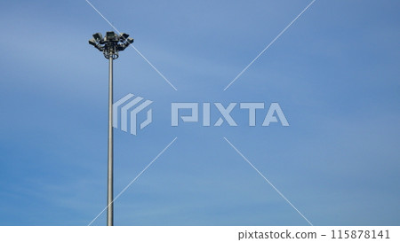 Spotlight pole on the side of the road The background is a blue sky Spotlight pole on the side of the road The background is a blue sky 115878141