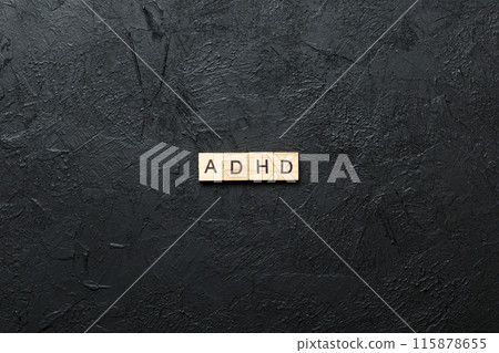 ADHD word written on wood block. ADHD text on table, concept 115878655